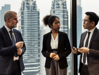 Business professionals discussing sustainable investment strategies amidst a skyscraper backdrop